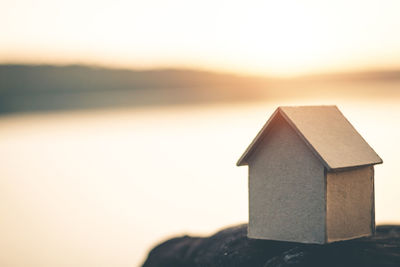 Close-up of birdhouse against house