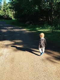 Boy walking on umbrella
