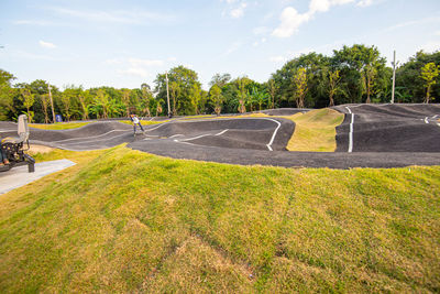 Road amidst trees against sky