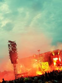 Group of people at music concert against sky