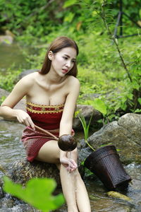 Young woman sitting outdoors