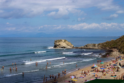 People on beach against sky