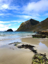 Scenic view of sea and mountains against sky