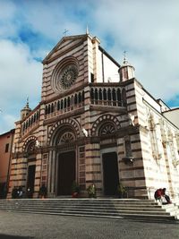 Low angle view of church against cloudy sky