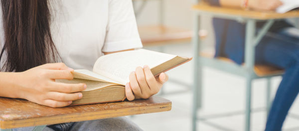 Close-up of woman hand holding book