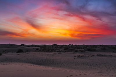 Scenic view of desert against sky during sunset