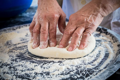 Cropped image of chef kneading dough