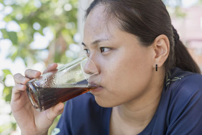 Close-up of woman drinking glass