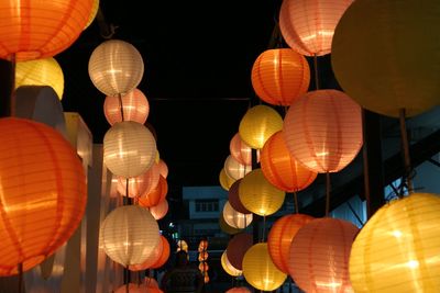 Low angle view of illuminated lanterns hanging at night