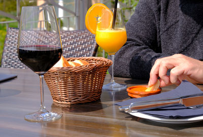 Cropped image of man having food and drink at table