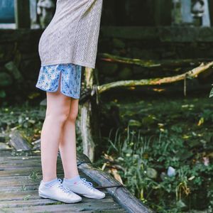 Low section of boy standing on tree