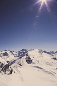 Scenic view of snowcapped mountains against clear sky