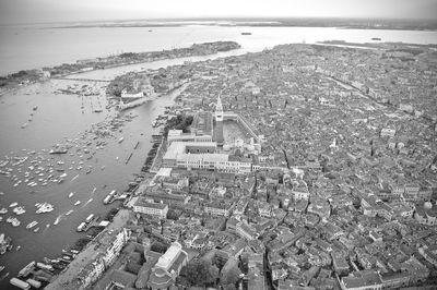 High angle view of townscape by sea against sky