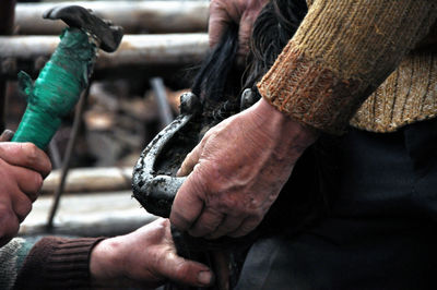 People working on horseshoe