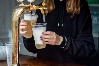 Midsection of woman drinking glass