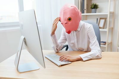 Portrait of woman using laptop on table