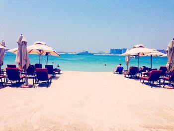 Scenic view of beach against clear blue sky