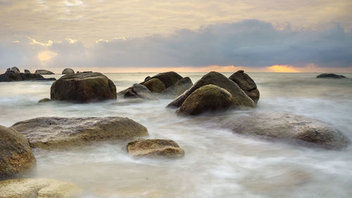 Scenic view of sea against cloudy sky