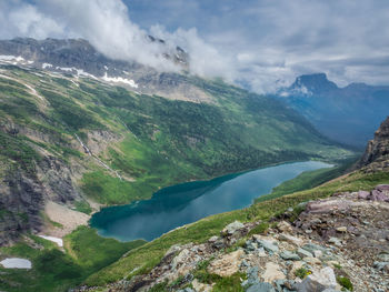 Scenic view of river amidst mountains against sky