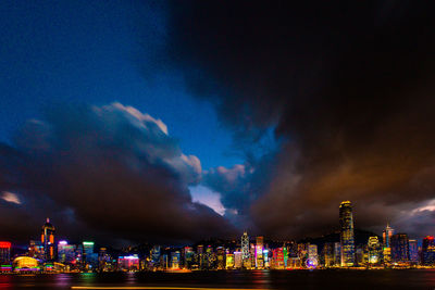 Illuminated city against sky at night