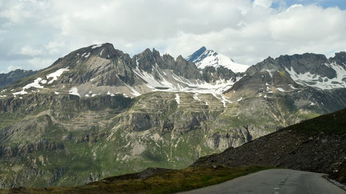 Scenic view of mountains against cloudy sky