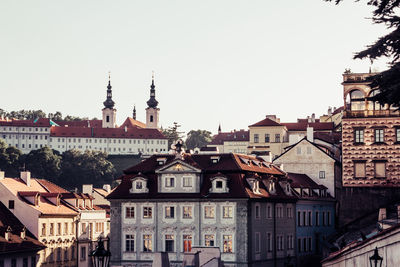 Buildings in city against clear sky