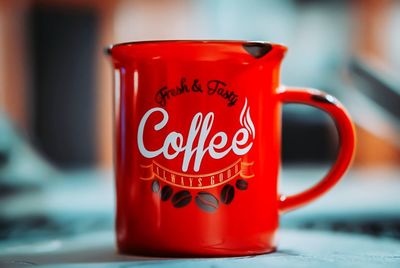Close-up of red tea cup on table