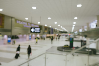 Blurred motion of people walking in airport