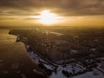 High angle view of buildings against sky during sunset