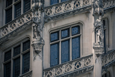 Low angle view of statue on old building columns