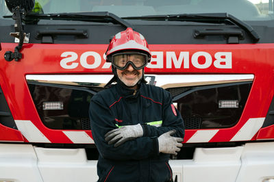 Rear view of man working in car