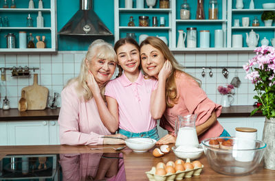 Portrait of cheerful family at kitchen