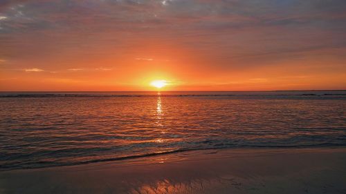 Scenic view of sea against romantic sky at sunset