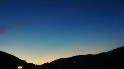 Scenic view of mountains against sky at night