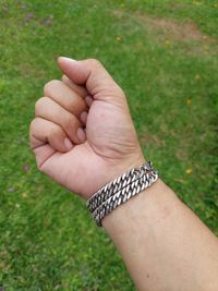 Close-up of human hand on grass