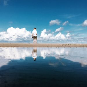 Rear view of woman standing in water