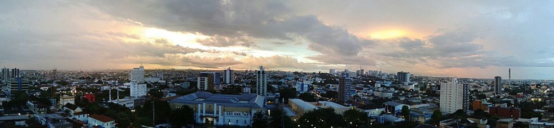 Cityscape against cloudy sky