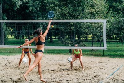 Beach tennis players at the net