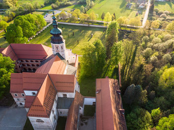 High angle view of trees and houses against buildings