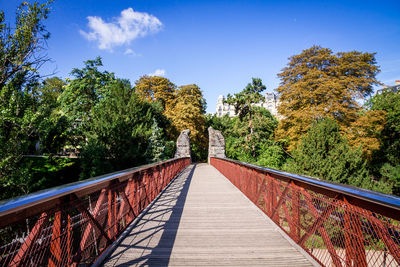 View of footbridge along trees