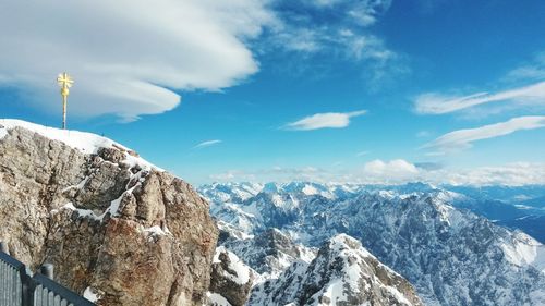 Scenic view of mountains against cloudy sky