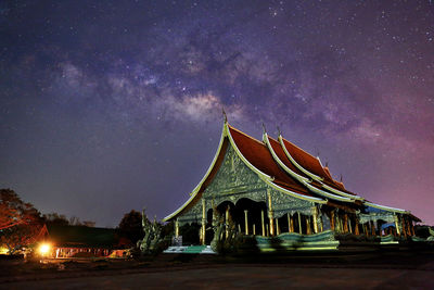 Low angle view of illuminated building against sky at night