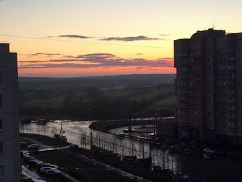 High angle view of buildings in city during sunset