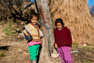 Portrait of a smiling girl standing outdoors