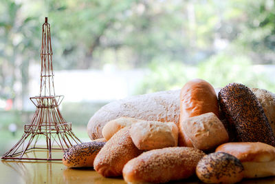 Close-up of breads with replica eiffel tower on table