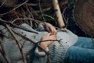 Midsection of woman lying amidst plants