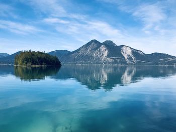 Scenic view of lake and mountains against sky