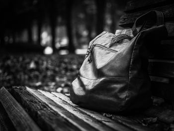 Close-up of shoulder bag on bench