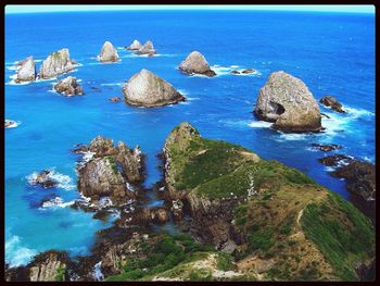 Scenic view of sea with rocks in background