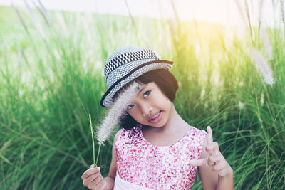 Portrait of cute girl wearing hat on field